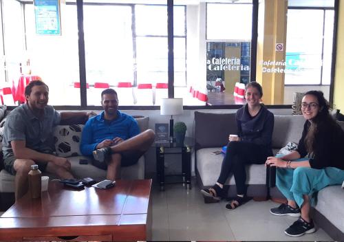 a group of people sitting on couches in a store at La Merced Plaza Hospedaje in Riobamba