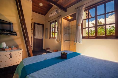 Cama ou camas em um quarto em Pousada Villa Lagoa das Cores
