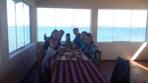 a group of people sitting at a table at Posada de Oliver in Llachon