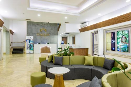 a living room with a couch and a table at Grand Plaza Hotel in Tumon