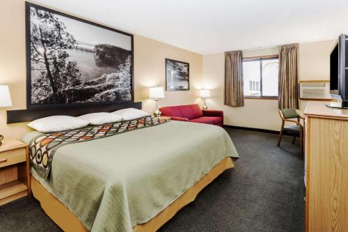 a hotel room with a bed and a tv at Super 8 by Wyndham Ottawa Starved Rock in Ottawa