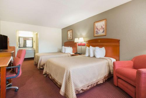 A bed or beds in a room at Days Inn by Wyndham Paintsville