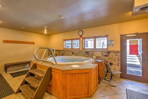a large bathroom with a tub and a sink at Walk to Ski Slopes and Main St Cozy Breck Condo! in Breckenridge