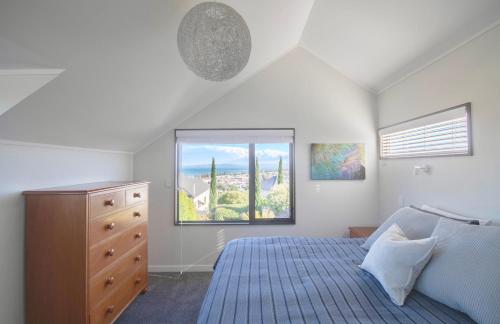 a bedroom with a bed and a window at Central City Gem - Napier Holiday Home in Napier