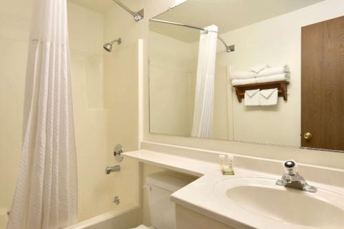a white bathroom with a sink and a mirror at Super 8 by Wyndham Jackson Hole in Jackson