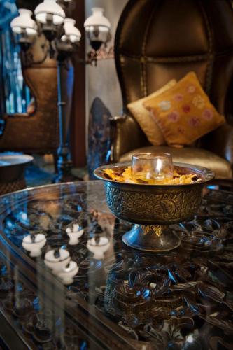 a glass table with a bowl of food on top of it at The Royal Surakarta Heritage - Handwritten Collection in Solo