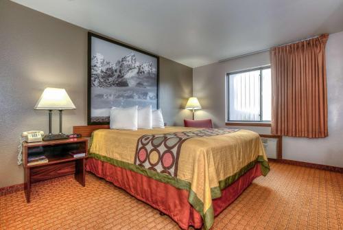 a hotel room with a large bed and a window at Super 8 by Wyndham Jackson Hole in Jackson