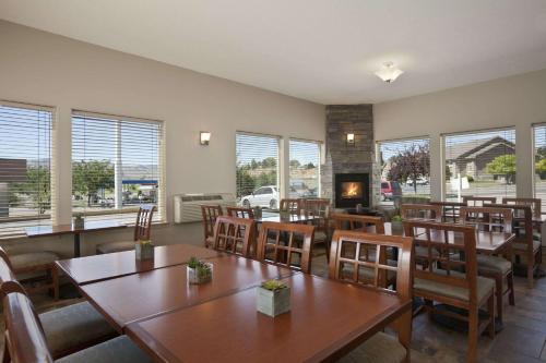 a restaurant with tables and chairs and a fireplace at Super 8 by Wyndham Pocatello in Pocatello