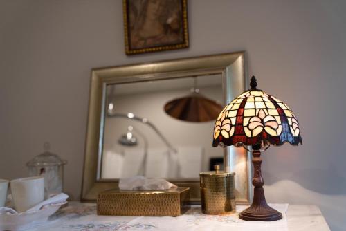 a lamp sitting on a table in front of a mirror at Villa Akaroa - Akaroa Pet Friendly Holiday Home in Akaroa