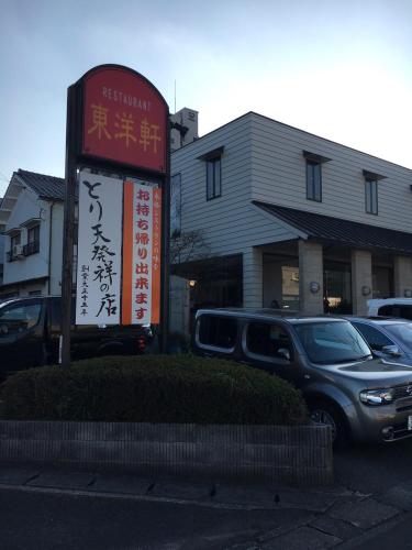 a sign in a parking lot in front of a building at Cocolie BEPPU in Beppu