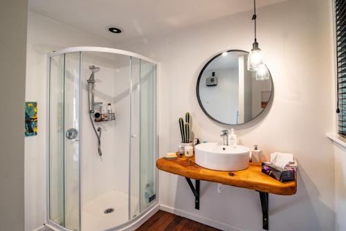 a bathroom with a sink and a shower at The Grandstand - French Farm Holiday Home in French Farm