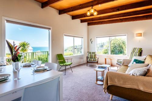a living room with a couch and a table at The Island Gem - Oneroa Holiday Home in Oneroa
