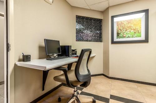 an office with a desk with a computer and a chair at Candlewood Suites Lincoln by IHG in Lincoln