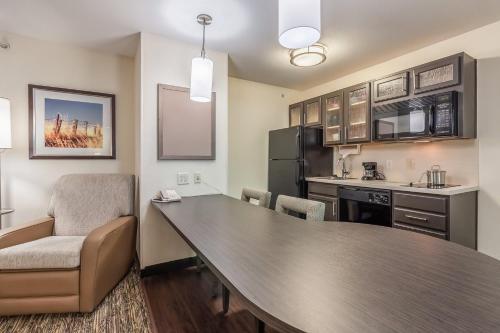 a kitchen with a table and chairs in a room at Candlewood Suites Lincoln by IHG in Lincoln
