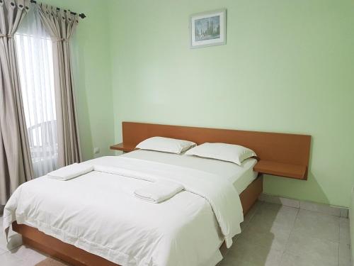 Giường trong phòng chung tại Komodo Boutique Hotel