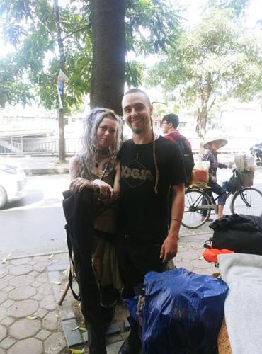 a man and a woman standing on a sidewalk at N'stay - Netfix Stay room- Cafe Film Netflix - Bar cafe & drinks 2424 in Hanoi