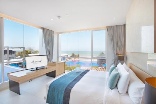a bedroom with a bed and a view of the ocean at Ace of Hua Hin Resort - SHA PLUS in Cha Am