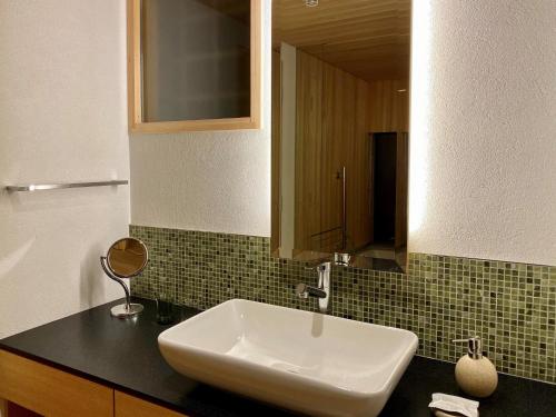a bathroom with a white sink and a mirror at Kamakura COCON in Kamakura