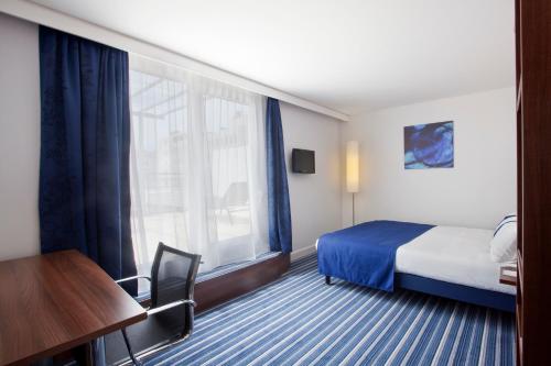 a hotel room with a bed and a window at Hôtel Marseille Centre Gare Saint-Charles in Marseille