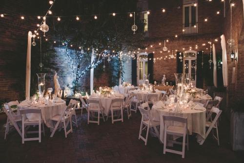 a dining room with white tables and chairs and lights at Holiday Inn Hotel French Quarter-Chateau Lemoyne by IHG in New Orleans