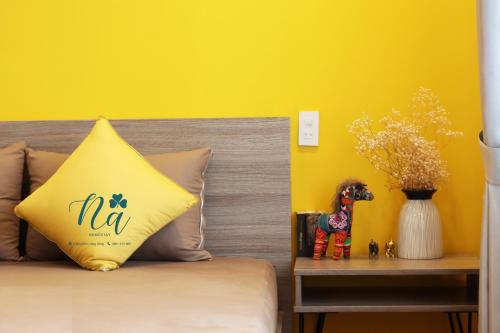 a bed with a nca pillow on top of it at Na Homestay in Hue