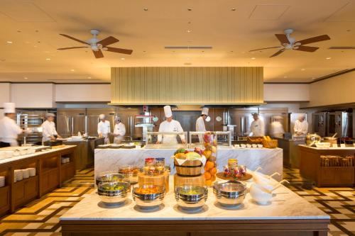 a large kitchen with chefs in the background at InterContinental Yokohama Grand by IHG in Yokohama