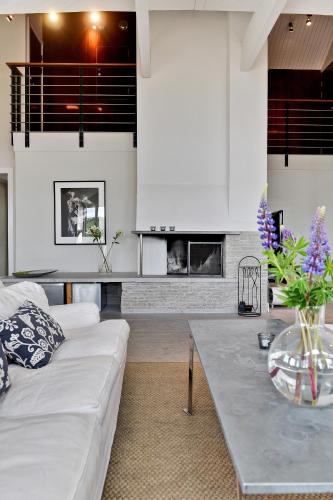 a living room with a white couch and a table at Sands Hotell in Sandhamn