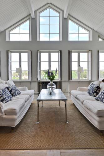a living room with two couches and a table at Sands Hotell in Sandhamn