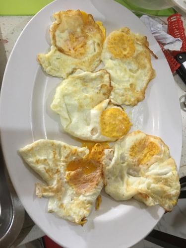 a plate of food with fried eggs on it at The Octagon wing A in Beau Vallon