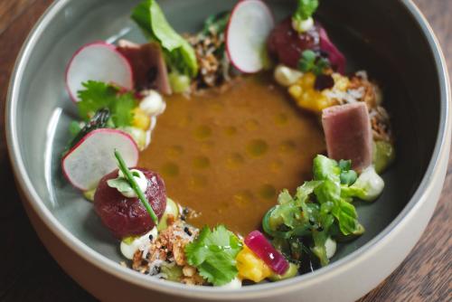 a bowl of food with meat and vegetables on a table at Hotel Detmolder Hof in Detmold