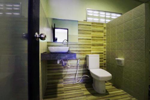a bathroom with a sink and a toilet at OYO 547 Happy Home in Bangkok