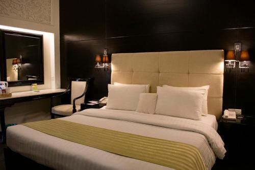 En eller flere senger på et rom på Hotel Margala