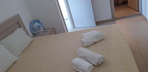two rolls of towels sitting on top of a bed at Avra Studios in Masouri