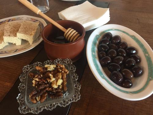 a table with a plate of food and a bowl of grapes at Hotel Villa Sevasti in Katerini