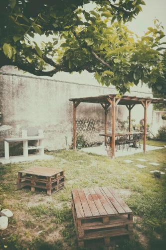 a picnic table and benches in a park at Little Room - Camera indipendente nella Torre in Pontassieve