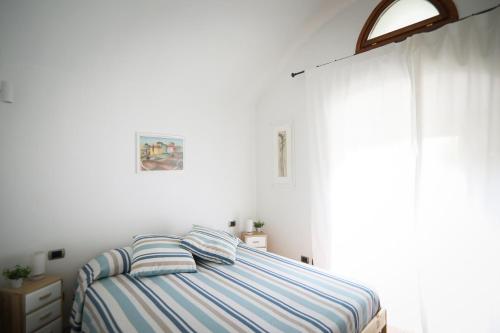 a bedroom with a bed and a large window at Little Room - Camera indipendente nella Torre in Pontassieve