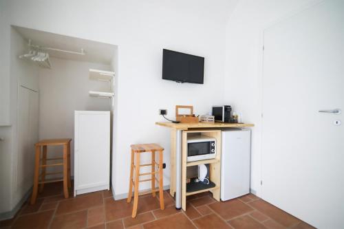 a room with a small table and two stools at Little Room - Camera indipendente nella Torre in Pontassieve