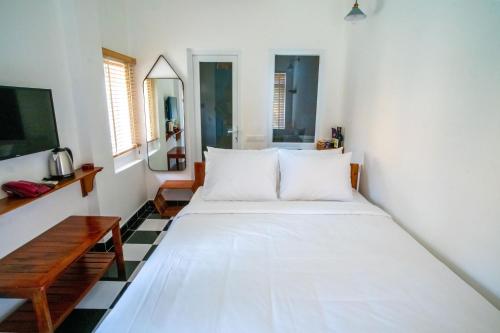 a bedroom with a large white bed in a room at Vida Loca Sunset Beach Resort in Phu Quoc