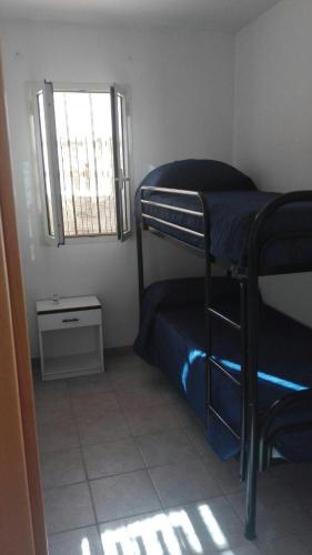 a small room with a bunk bed and a window at Casa vacanze Leonardo in Peschici