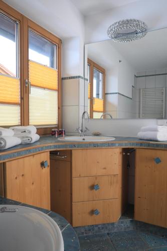 uma casa de banho com um lavatório e um espelho grande em Haus Luna em Schwangau