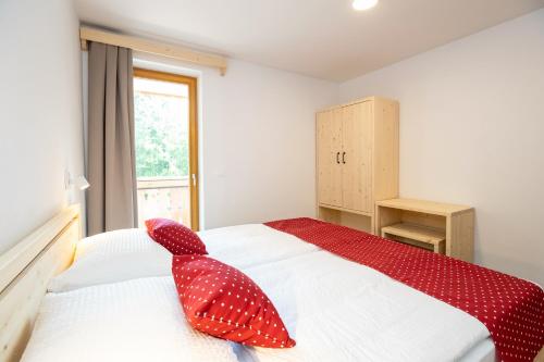 a bedroom with a bed with a red shark head on it at Bohinj Apartments Goldhorn Kingdom in Bohinj