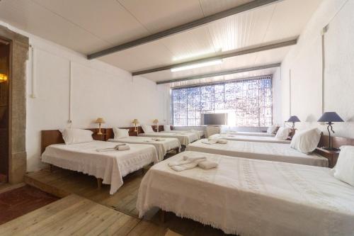 Säng eller sängar i ett rum på Hospedaria São Bras