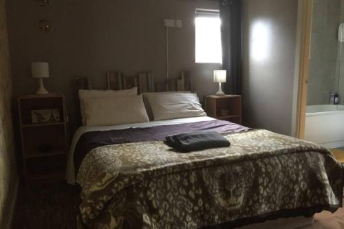 a bedroom with a bed and a bath tub at Cosy rural self catering annex in Magherafelt