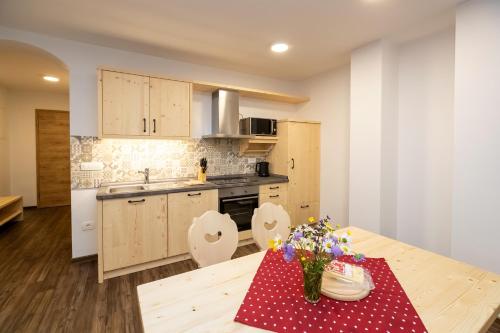 a kitchen with a table with a red and white polka dot table cloth at Bohinj Apartments Goldhorn Kingdom in Bohinj
