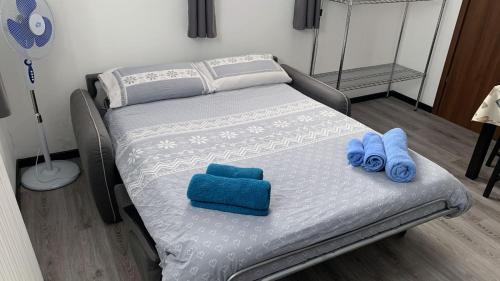 a bed with blue towels on it in a room at Studio CENTRAL 2 in Aosta