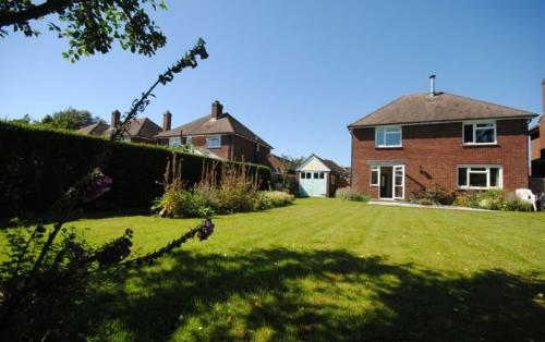 a large yard with a brick house and a hedge at Beacon Square, Emsworth in Emsworth