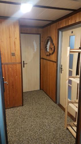 a room with a door and a room with bunk beds at Chata Tanvaldský Špičák in Tanvald