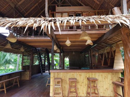 a bar in a bamboo house with stools at Antonio's Ko Yao Noi in Ko Yao Noi