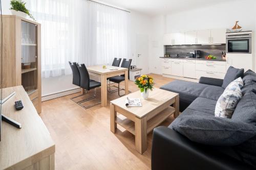 a living room with a couch and a table at Haus Elimar Weber in Norderney