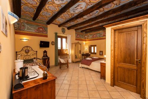 a hotel room with a bed and a bathroom at Palazzo Lauritano in Agerola